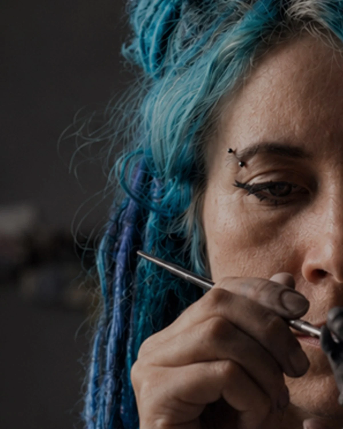 The maker in her studio, surrounded by handmade art dolls and ceramic tea pets
